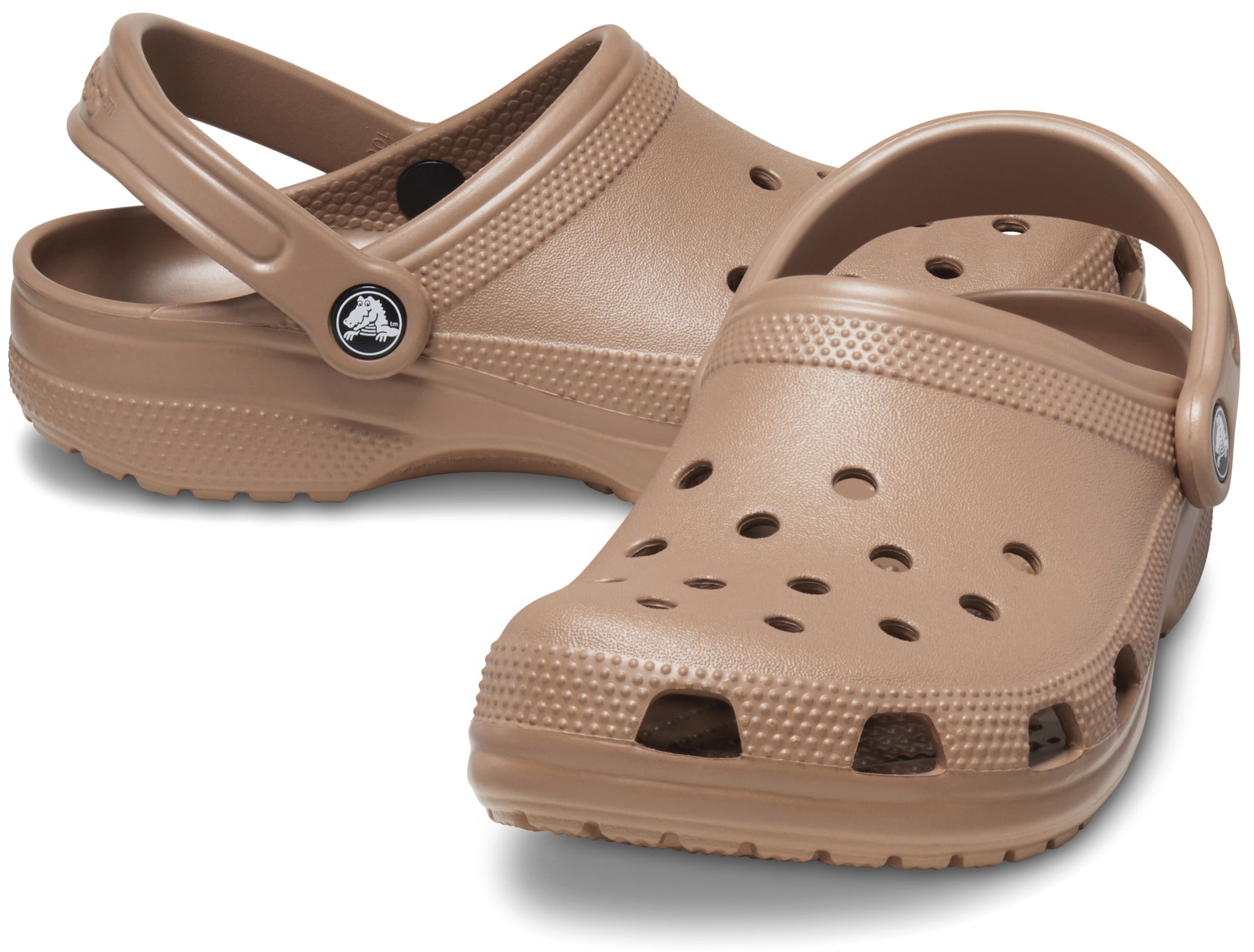 The Crocs Unisex Classic Clogs (10001-2Q9) in Latte by Crocs feature ventilation holes and heel straps for all-day comfort, shown against a white background.