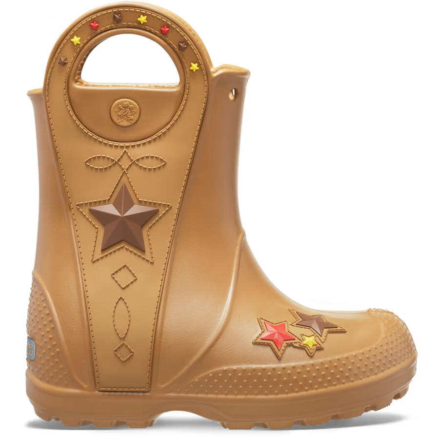 The Crocs Toddlers Handle It Western Boots (212549-2HI) in Umber feature a tan color, star and stitching details, cut-out handles, and colorful star accents near the toe for a western-inspired look.