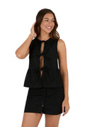 A woman smiles in the Ringers Western Womens Jynette Tie Front Top (225047RW) in black, styled with a coordinating black skirt that has button and embroidered details.