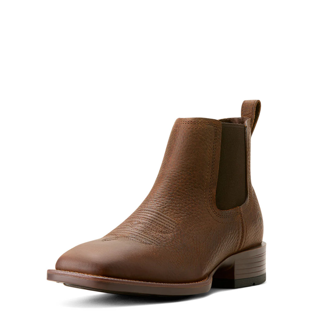 The Ariat Mens Booker Ultra Western Boots (10053654) in Brown Oiled Rowdy feature full-grain leather, a low heel, textured sides, elastic side panels, and a back pull tab, displayed on a white background.