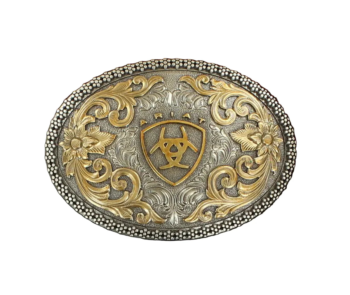 The Ariat Oval Beaded Edge Ariat Logo Buckle (A37005) features ornate gold and silver floral engravings, a detailed beaded edge, and a central shield with the Ariat logo—a classic example of Ariat's filigree buckle design.