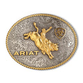 The Ariat Oval Rope Edge Bullrider Buckle (A37056) features aged silver and gold with a bull rider, gold "ARIAT" lettering, a small shield logo, and an intricate rope border—ideal for any rodeo fan.