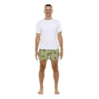 A man modelling a pair of sage green Bamboozld Mens Weiner Bamboo Boxer Shorts (BBW22UBSWEINER) with a dachshund print, paired with a plain white t-shirt, against a solid white background.