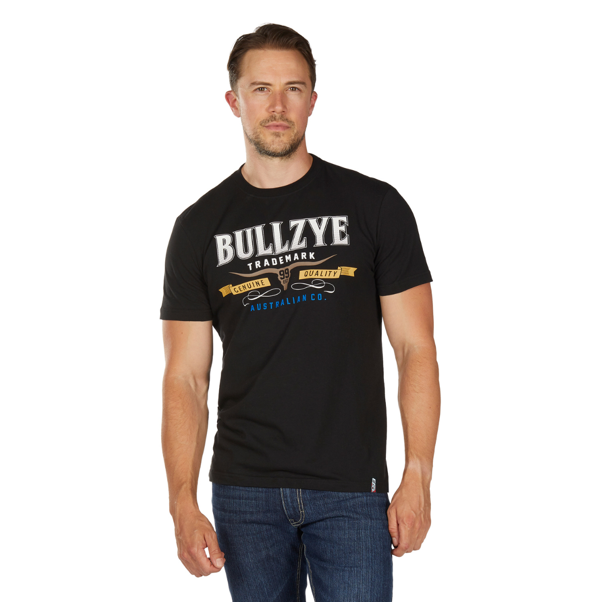 A man in blue jeans and a Bullzye Mens Trademark S/S Tee (B6W1503509) Black stands facing forward against a white background.