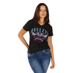 A woman with long brown hair poses with one hand on her hip against a white background, wearing the Bullzye Womens Jemma S/S Tee (B6W2503528) in black and blue jeans.