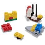 Crocs 4LW Masterbrand 5 Pack Jibbitz Shoe Charms (10018243) by Crocs features four colorful LEGO-inspired designs—a yellow wall, sailboat, red and yellow bricks, and a small spaceship—ideal for customizing your Crocs.