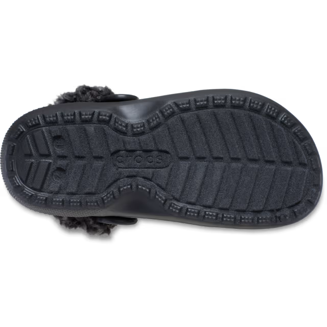 A sole of a black Crocs Children's Classic Fleece Lined Clog (212856-001) with fluffy dark grey faux-fur lining, shown on a clean white background.