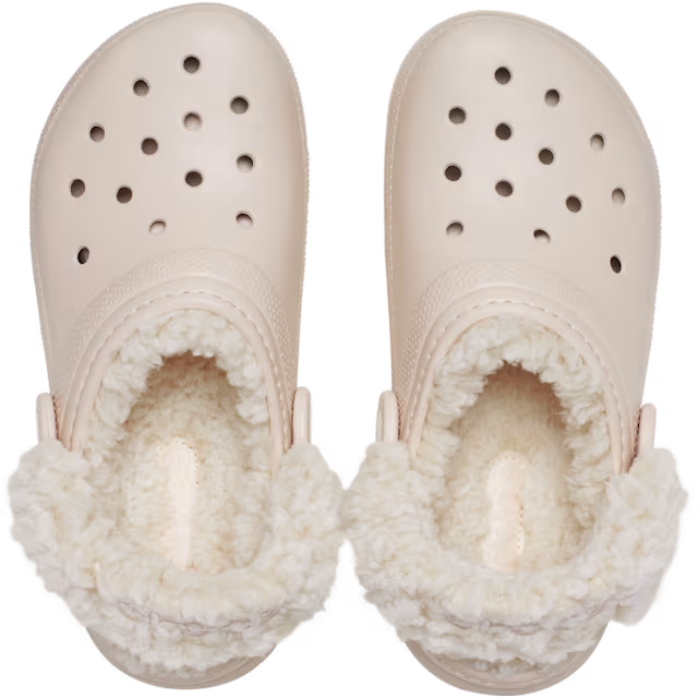 A pair of Crocs Children's Classic Fleece Lined Clogs (212856-6UR) in a quartz colour, featuring a plush cream sherpa lining inside and a matching textured strap with a circular logo button.
