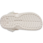The bottom sole of a quartz coloured Crocs Children's Classic Fleece Lined Clog (212856-6UR) featuring the embossed Crocs logo in the centre and a textured tread pattern.