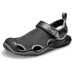 A black and grey Crocs Men's Swiftwater Mesh Deck Sandal (205289-001) 3-4 front view, displayed on a clean white background.