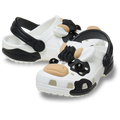 The Crocs Toddlers Classic IAM Cow Clogs (212902-100) in white feature a fun black and white cow design with 3D face, ears, snout, and spots—perfect for kids who love playful footwear.