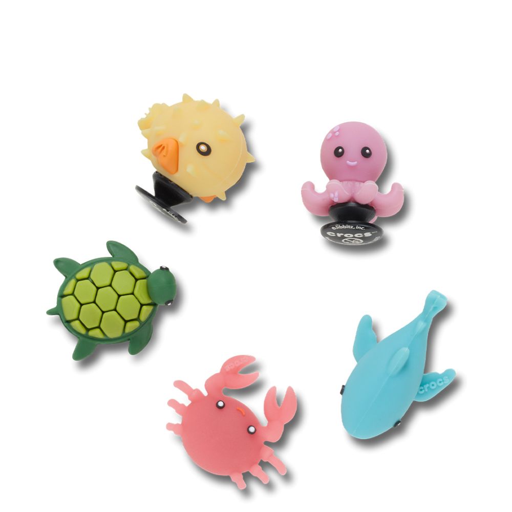 The Crocs UV Changing Sea Animals 5 Pack Jibbitz Shoe Charms (10018478) by Crocs features colorful pufferfish, octopus, turtle, crab, and shark charms arranged in a circle on a white background.