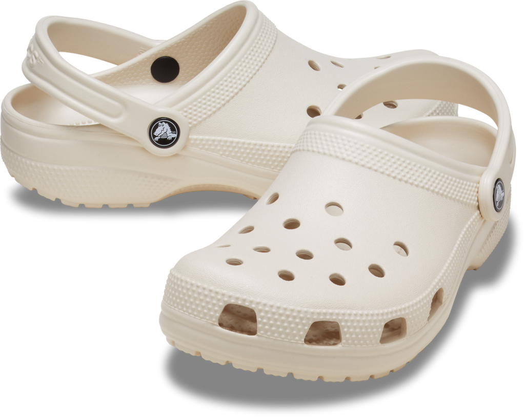 The Crocs Childrens Classic Clogs (206991-2MC) Frappe by Crocs feature ventilation holes and a heel strap in a beige color—ideal water-friendly clogs to add to your kids' daily shoe collection.