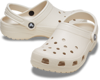 The Crocs Childrens Classic Clogs (206991-2MC) Frappe by Crocs feature ventilation holes and a heel strap in a beige color—ideal water-friendly clogs to add to your kids' daily shoe collection.