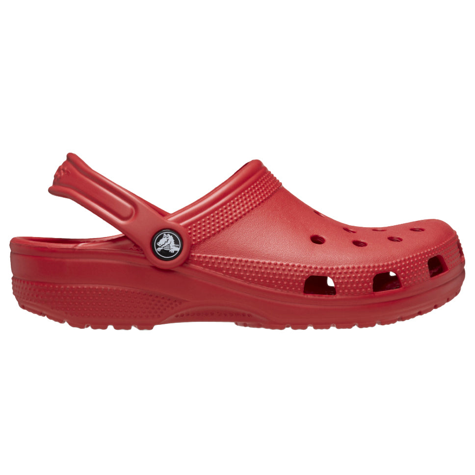 A single varsity red Crocs Unisex Classic Clog (10001-6WC) shown in side profile on a plain white background. The shoe has multiple ventilation holes, a textured upper, a contoured sole, and a small circular Croc logo medallion near the strap attachment.