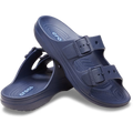 Crocs Mens Saturday Sandals (212245-410) in navy by Crocs feature two adjustable straps per shoe, textured footbeds for comfort, and a side logo. One sandal stands upright while the other leans against it.