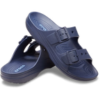 Crocs Mens Saturday Sandals (212245-410) in navy by Crocs feature two adjustable straps per shoe, textured footbeds for comfort, and a side logo. One sandal stands upright while the other leans against it.