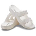 A pair of Crocs Womens Saturday Sandals (213586-100) in white, each with two adjustable straps—one sandal upright, the other leaning against it on a plain background—crafted for signature Crocs comfort.