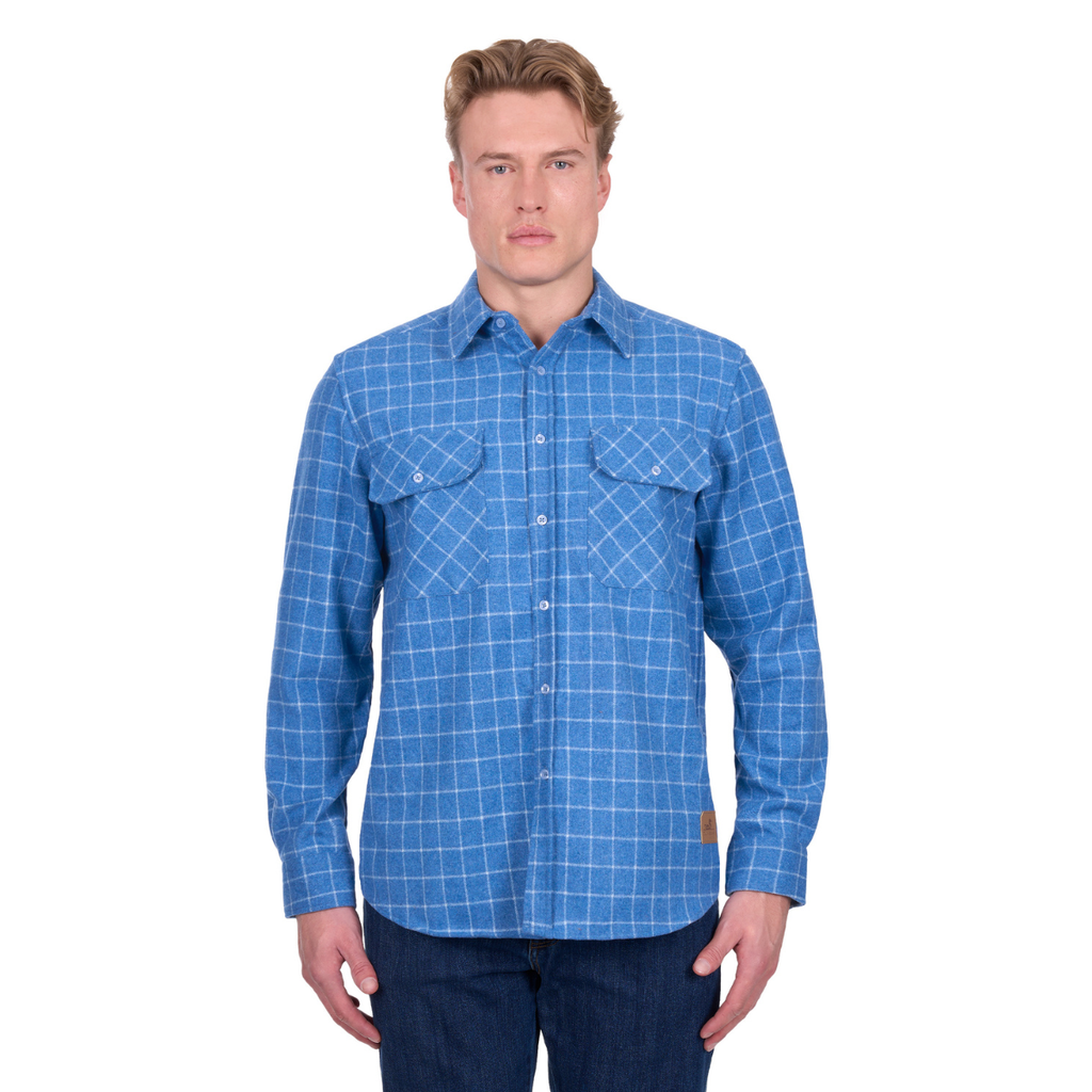 A man faces forward wearing the Dux-Bak Mens Amir L/S Thermal Shirt (D6W1116203) in steel blue, a long-sleeve button-up with two chest pockets and a white check pattern, paired with dark jeans. Brand: Dux-Bak.