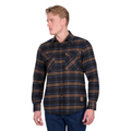 A man in blue jeans and light hair wears the Dux-Bak Mens Hunter L/S Thermal Shirt (D6W1116205) in Navy/Dark Tan, a long-sleeve, button-up check shirt with front pockets, as he stands looking to his left.