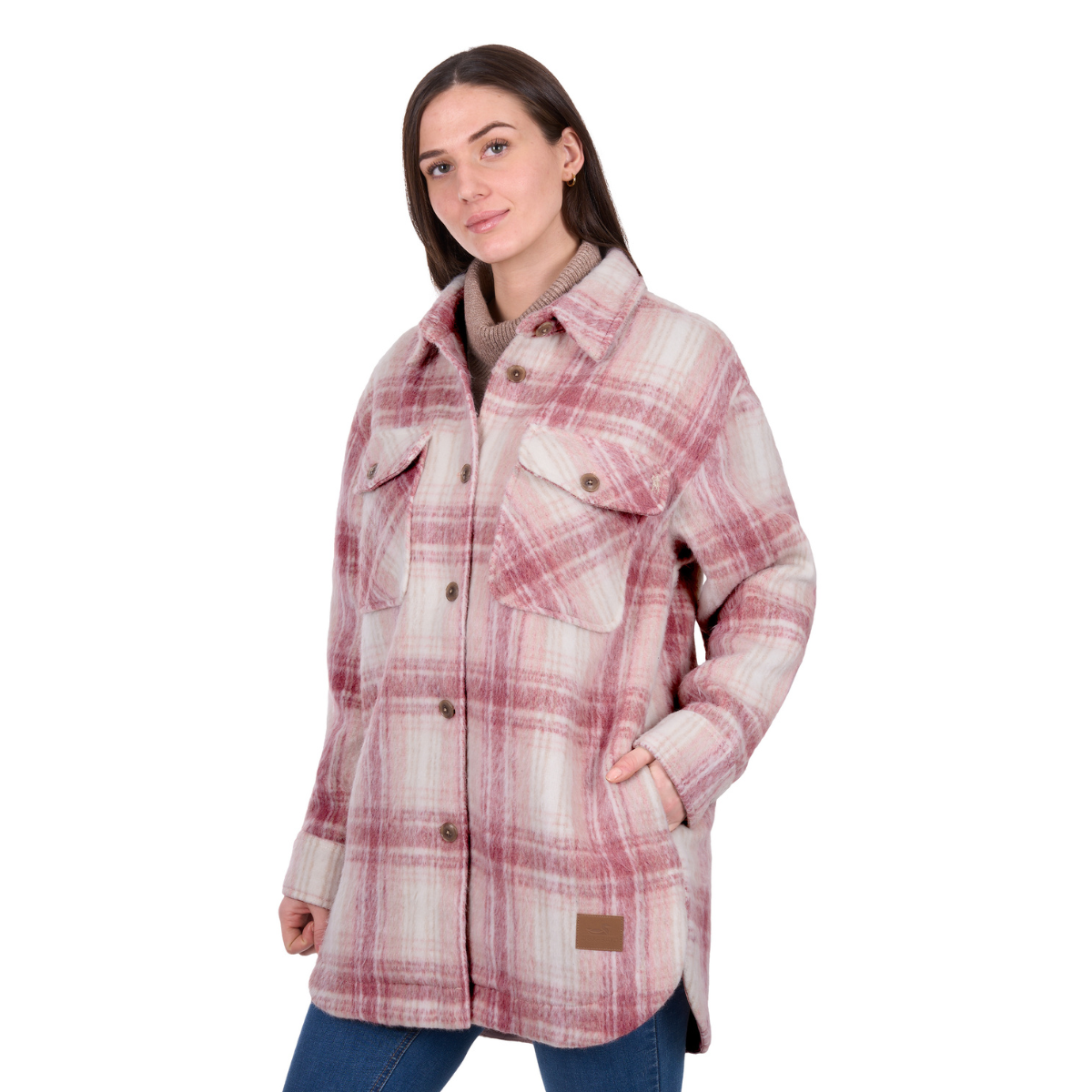 A woman wears the Dux-Bak Womens Elk L/S Overshirt (D6W2103059) in pink—a heavyweight plaid layer with large front pockets—paired with blue jeans, standing against a white background.