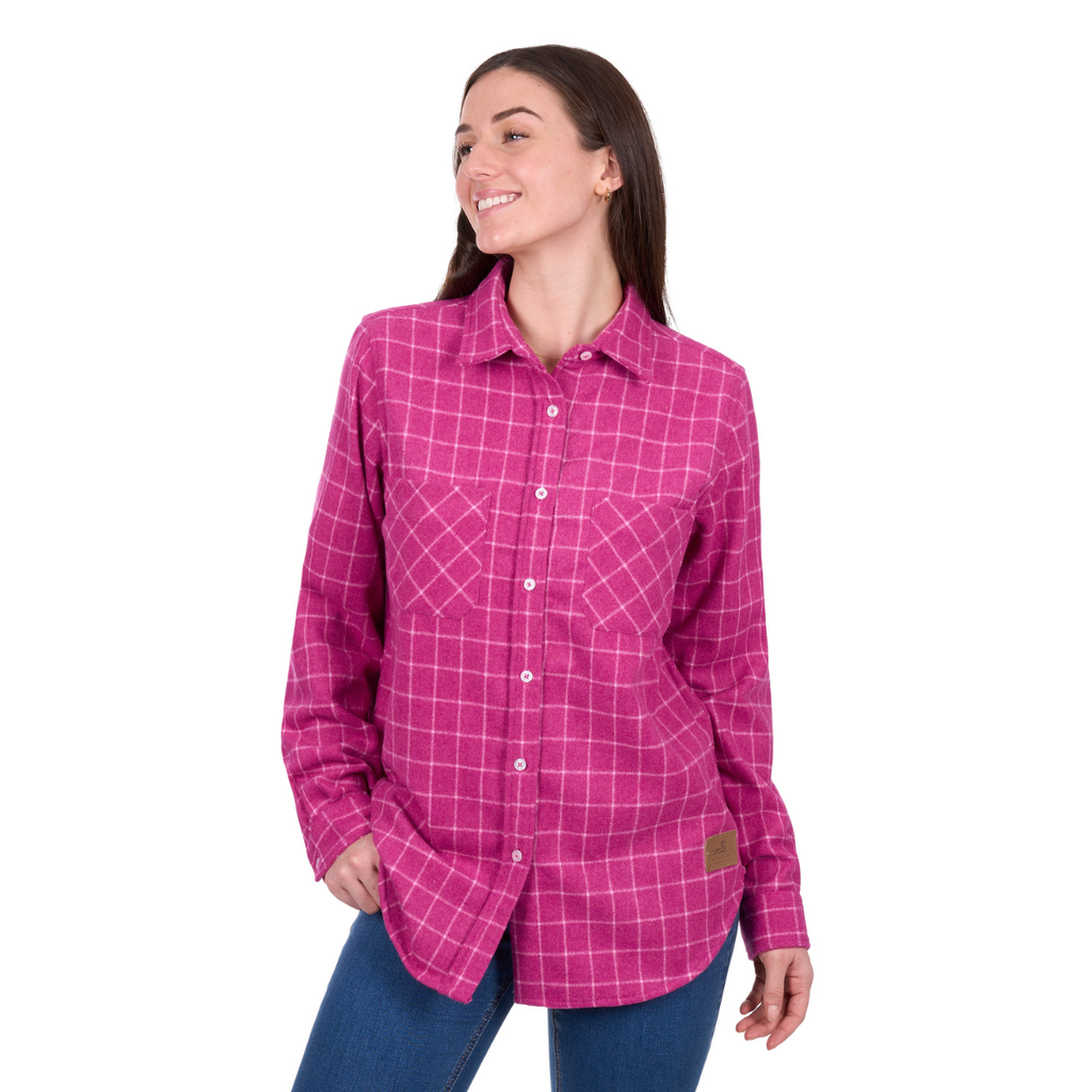 A woman smiles to her left, wearing a Dux-Bak Womens Jazz L/S Thermal Shirt in Hot Pink (D6W2150111) and blue jeans. Her right hand is in her pocket, left arm by her side, against a plain white background.