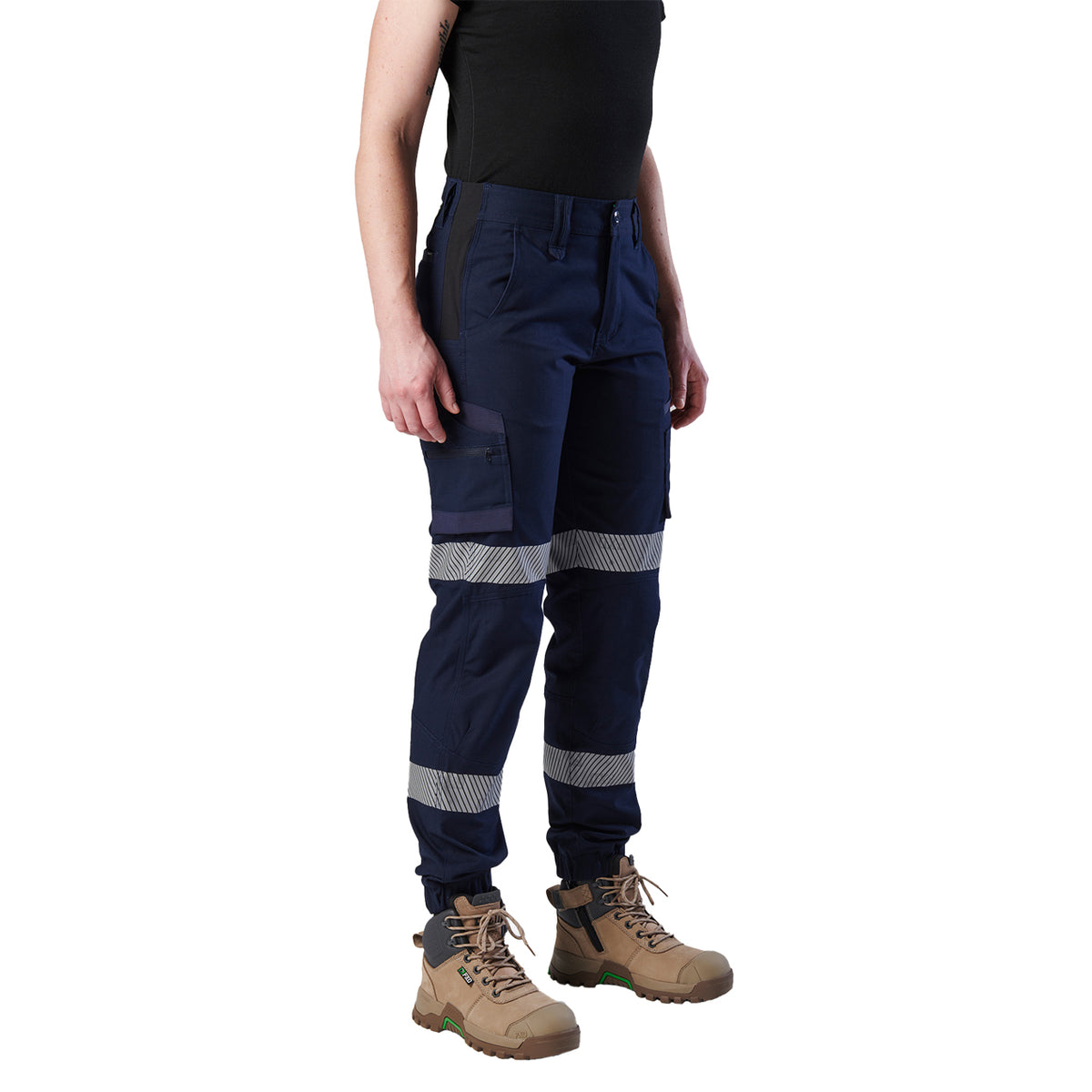 A 3-4 front view of a woman wearing a pair of navy blue FXD Women's Cuffed Taped Work Pants (WP-8WT) with reflective silver-grey bands on the legs, paired with a black t-shirt and stone coloured boots, against a plain white background.
