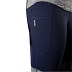 A close up view of the pocket of a pair of navy FXD Women's Taped Work Leggings (WP-9WT) paired with a grey tee on a white background.