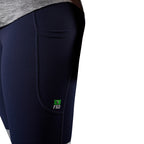 A close up view of the pocket of a pair of navy FXD Women's Taped Work Leggings (WP-9WT) paired with a grey tee on a white background.