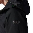 Close-up of a woman modelling a black hooded FXD Women's WO-1W Insulated Waterproof Jacket (FX12407001) with an FXD logo on the upper sleeve and small bright green drawcord accents near the hood.