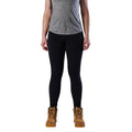 A woman modelling a black pair of FXD Women's Work Leggings (WP-9W) paired with a grey tee and wheat coloured work boots against a white background.