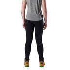 A woman from behind modelling a black pair of FXD Women's Work Leggings (WP-9W) paired with a grey tee and wheat coloured work boots against a white background.