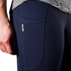 A close up of the pocket detail on a pair of navy blue FXD Women's Work Leggings (WP-9W) paired with a grey tee on a white background.