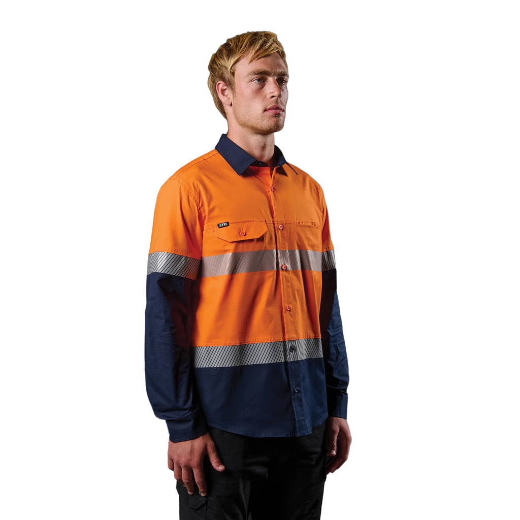 A 3-4 right view of a man wearing an orange and navy FXD Men's LSH-4T Vented Tech Hi-Vis Long Sleeve Work Shirt (FX02504010) with hi vis tape and a pair of black work pants on a white background.