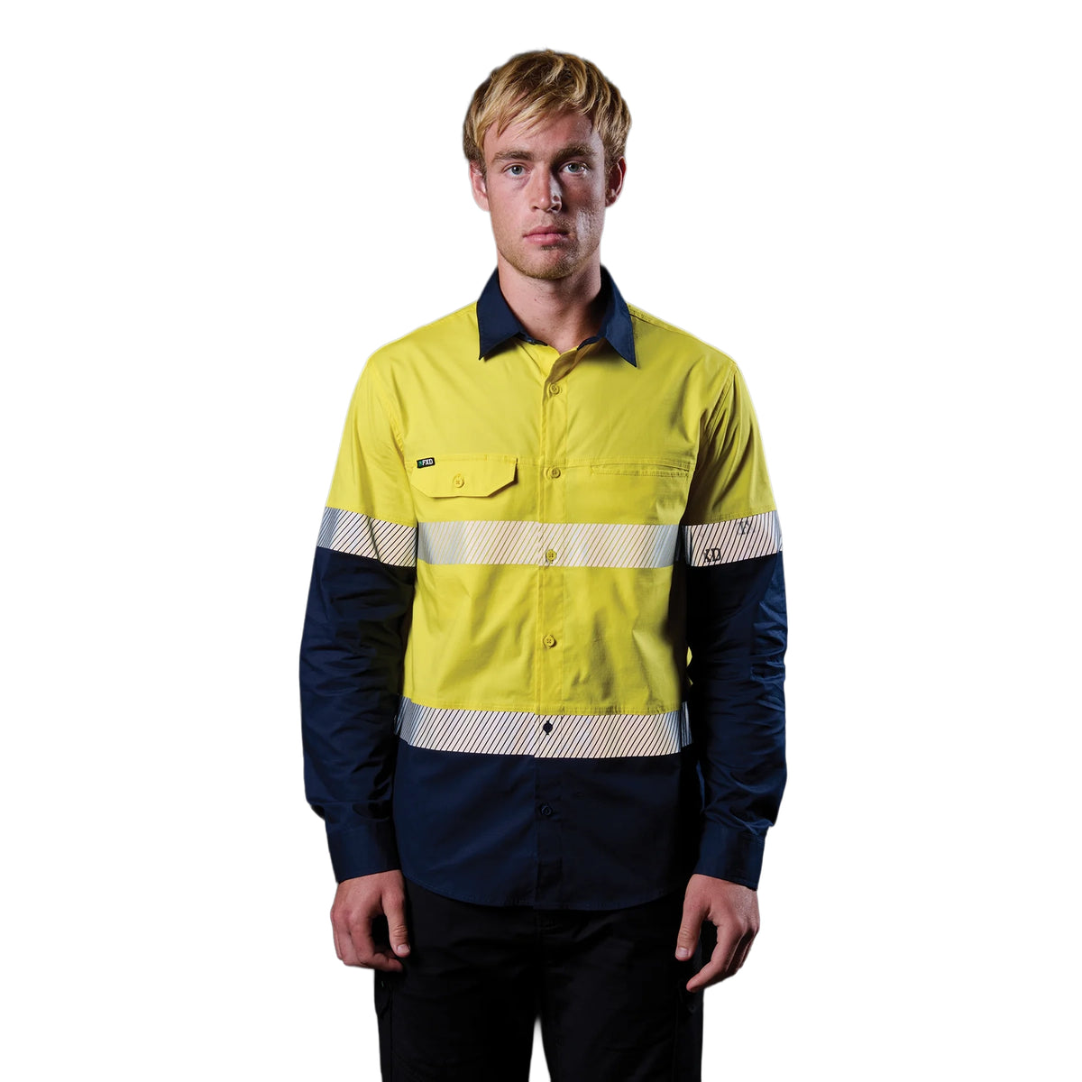 A man wearing a yellow and navy FXD Men's LSH-4T Vented Tech Hi-Vis Long Sleeve Work Shirt (FX02504010) with hi vis tape and a pair of black work pants on a white background.