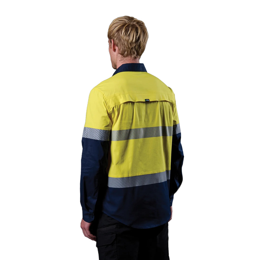 A 3-4 back left view of a man wearing a yellow and navy FXD Men's LSH-4T Vented Tech Hi-Vis Long Sleeve Work Shirt (FX02504010) with hi vis tape and a pair of black work pants on a white background.