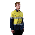 A 3-4 right view of a man wearing a yellow and navy FXD Men's LSH-4T Vented Tech Hi-Vis Long Sleeve Work Shirt (FX02504010) with hi vis tape and a pair of black work pants on a white background.