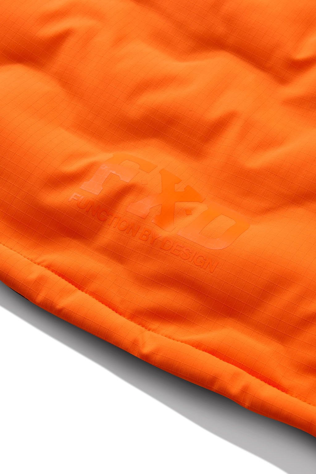 The FXD Mens WO-6 Puffer Vest (FX02407005) in bright orange features black side panels, front zipper, high collar, quilted padding, water-repellent finish, and FXD logo patches on the left chest and lower right.