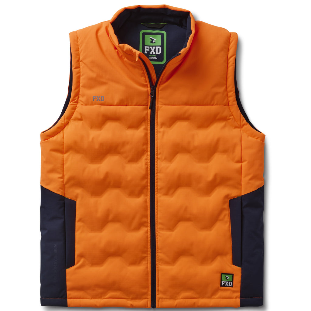 The FXD Mens WO-6 Puffer Vest (FX02407005) in bright orange features black side panels, front zipper, high collar, quilted padding, water-repellent finish, and FXD logo patches on the left chest and lower right.