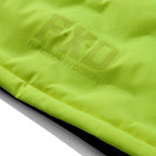 The FXD Mens WO-6 Puffer Vest (FX02407005) in yellow is a sleeveless, water-repellent insulated vest with black side panels, black zipper, high collar, padded warmth, and FXD branding on the chest and lower left hem.