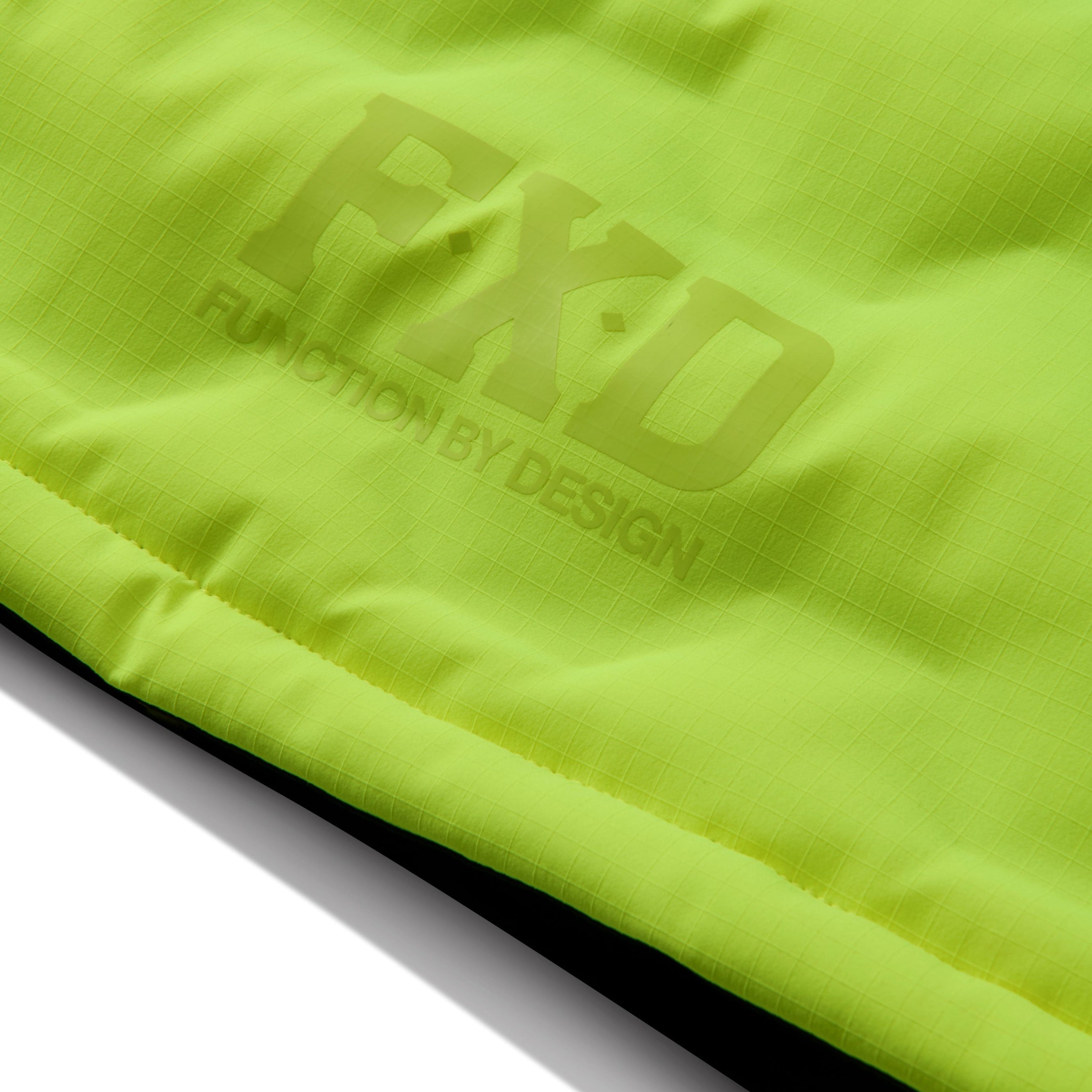The FXD Mens WO-6 Puffer Vest (FX02407005) in yellow is a sleeveless, water-repellent insulated vest with black side panels, black zipper, high collar, padded warmth, and FXD branding on the chest and lower left hem.