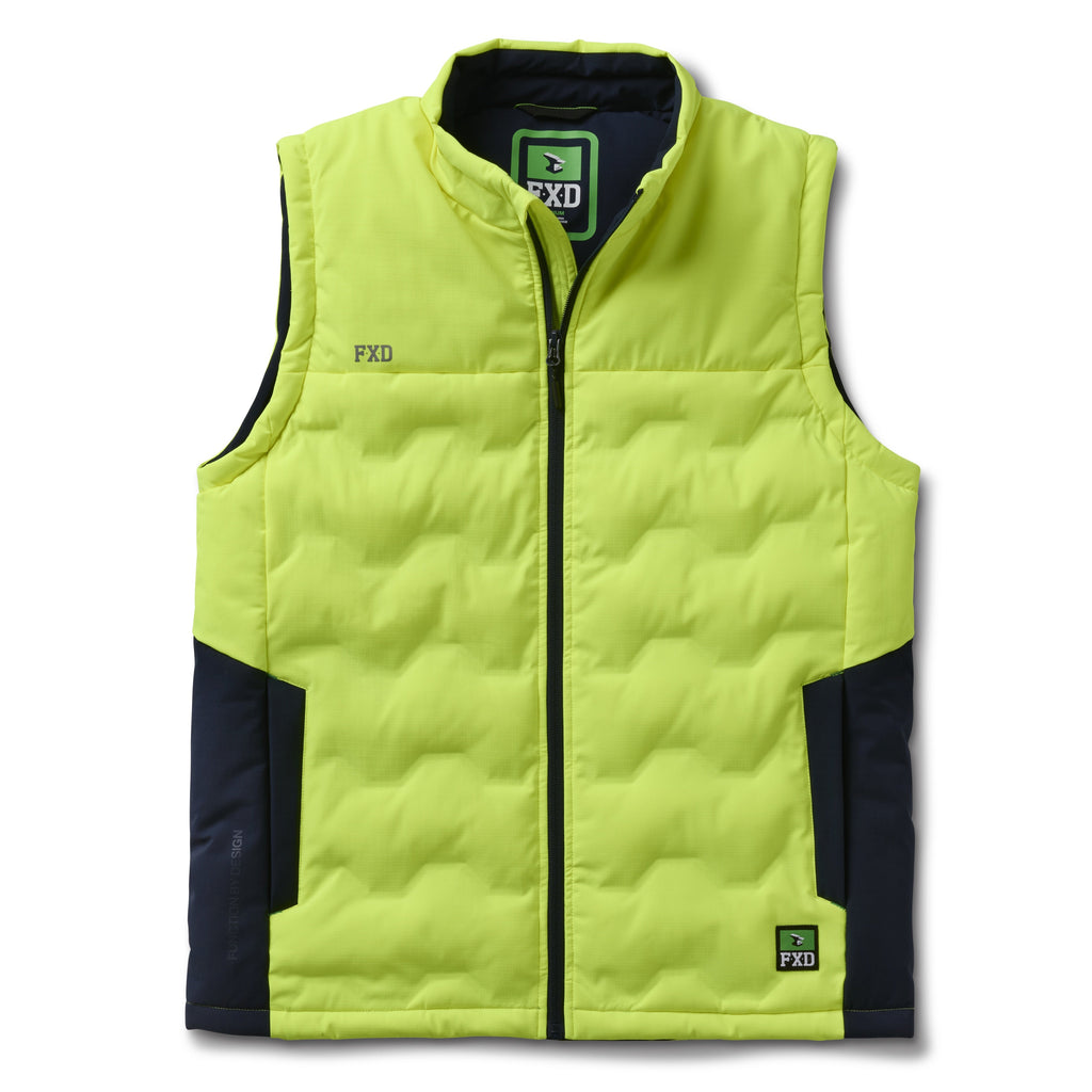 The FXD Mens WO-6 Puffer Vest (FX02407005) in yellow is a sleeveless, water-repellent insulated vest with black side panels, black zipper, high collar, padded warmth, and FXD branding on the chest and lower left hem.