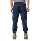 A back view of a man wearing navy cargo style FXD WP-12C Elastic Waist Stretch Ripstop Cuffed Work Pants (FX02506027) with a drawstring waist and stone work boots, shown from the waist down on a plain white studio background.