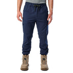A front view of a man wearing navy cargo style FXD WP-12C Elastic Waist Stretch Ripstop Cuffed Work Pants (FX02506027) with a drawstring waist and stone work boots, shown from the waist down on a plain white studio background.