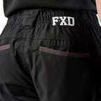 A close up of the back waist pocket detail on a pair of black cargo style FXD Men's WP-12 Elastic Waist Stretch Ripstop Work Pants (FX02506026) on a white background.