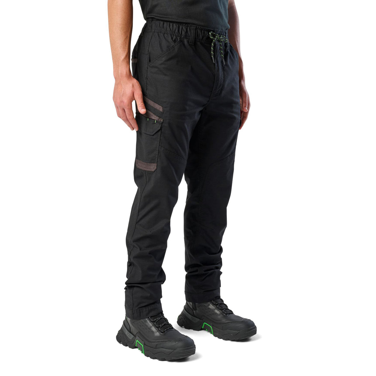 A 3-4 front view of a man wearing black cargo style FXD Men's WP-12 Elastic Waist Stretch Ripstop Work Pants (FX02506026) with black work boots on a white background.