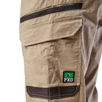 Close up of the pocket detail of a pair of khaki cargo style FXD Men's WP-12 Elastic Waist Stretch Ripstop Work Pants (FX02506026) on a white background.