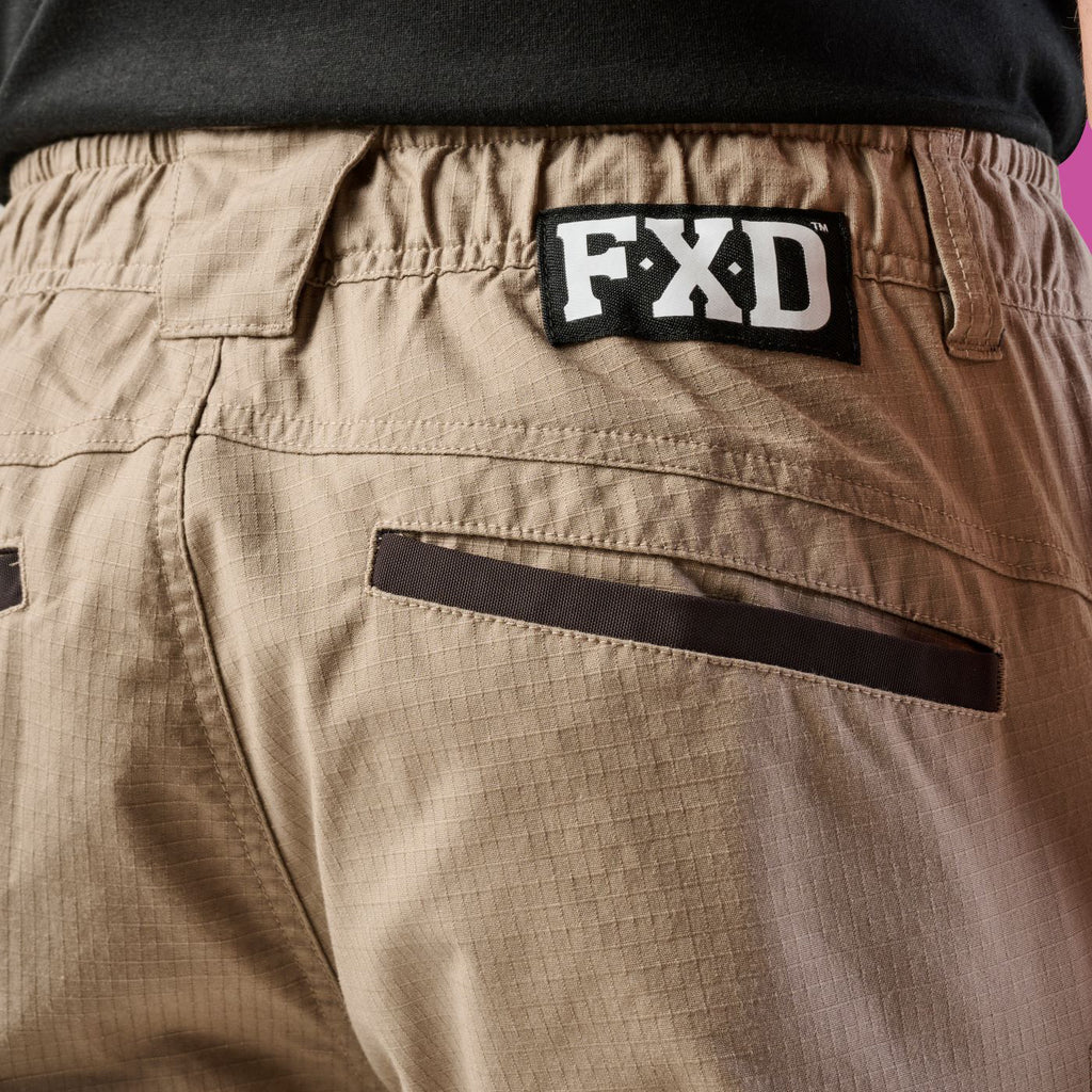 Close up of back waist detail of a pair of khaki cargo style FXD Men's WP-12 Elastic Waist Stretch Ripstop Work Pants (FX02506026) on a white background.