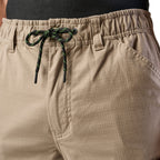 Close up waist detail of a pair of khaki cargo style FXD Men's WP-12 Elastic Waist Stretch Ripstop Work Pants (FX02506026) on a white background.