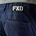 A close up of the back waist on a pair of navy blue cargo style FXD Men's WP-12 Elastic Waist Stretch Ripstop Work Pants (FX02506026) on a white background.